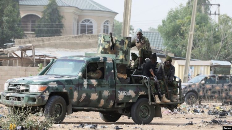 Nigerian military secure the area where a man was killed by suspected militants during an attack around Polo area of Maiduguri Nigeria 750x422 1